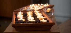 memorial candles burning in a tray