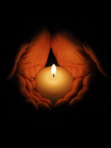 hands holding candle
